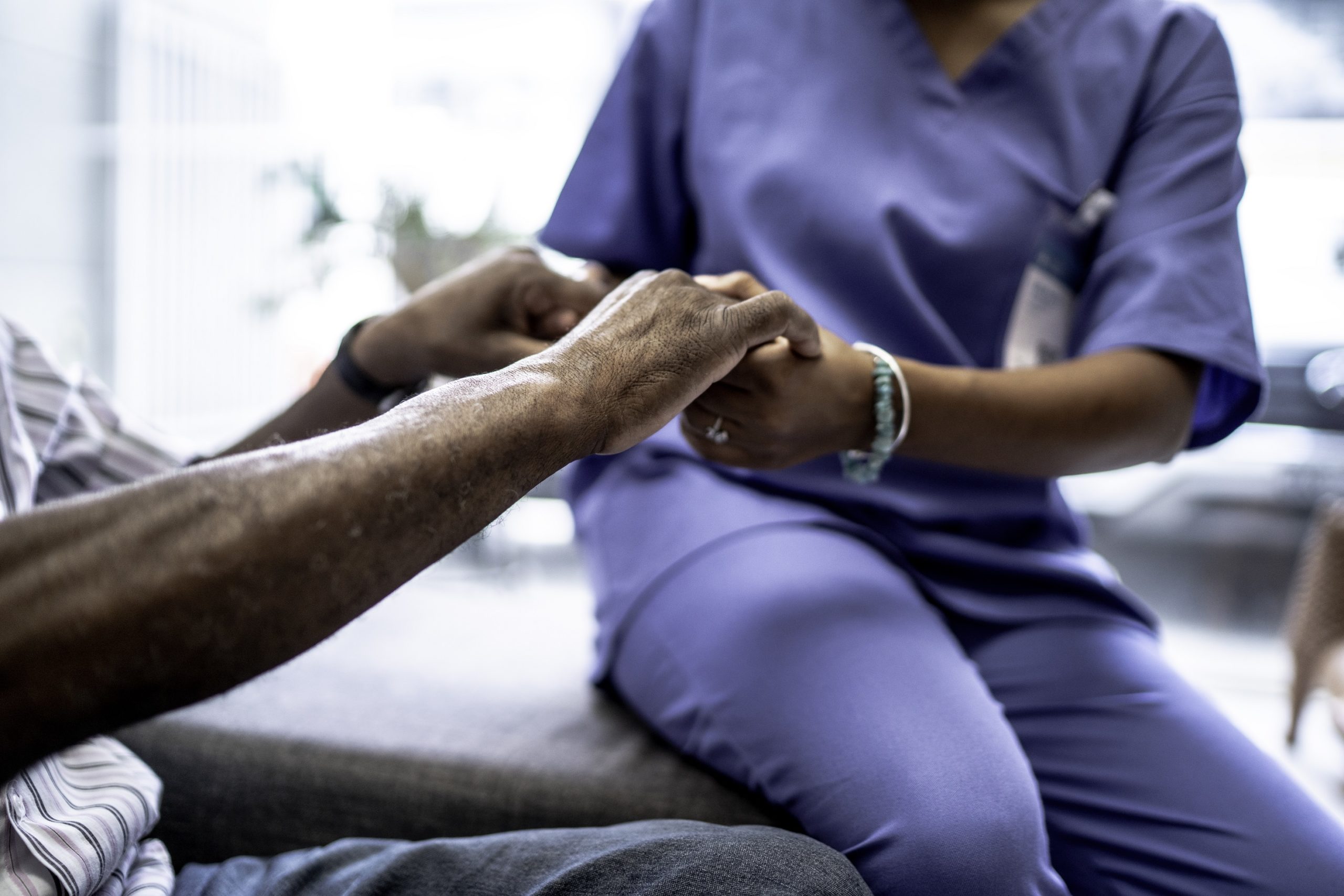 nurse holding patient's hands