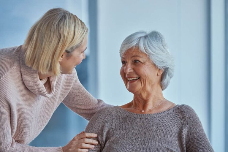 woman embracing senior woman