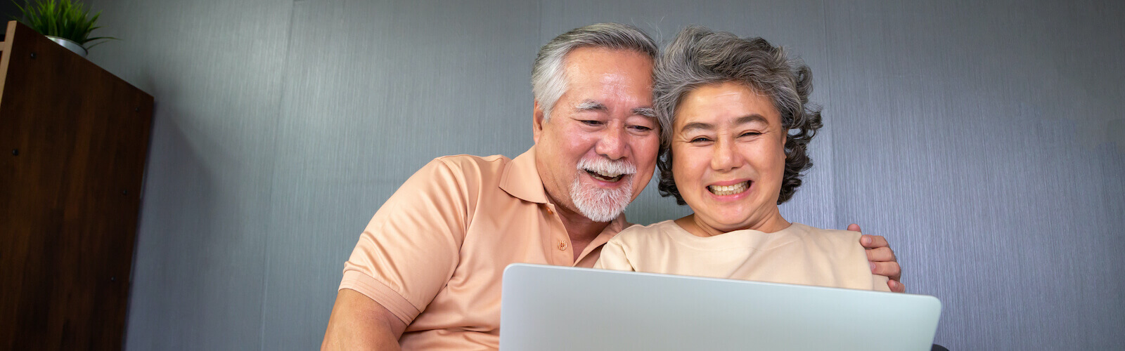 Asian senior couple talking to family