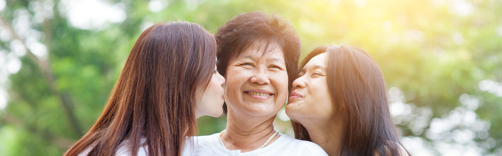 asian daughters kissing their mom