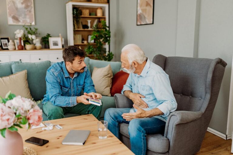 men talking around coffee table