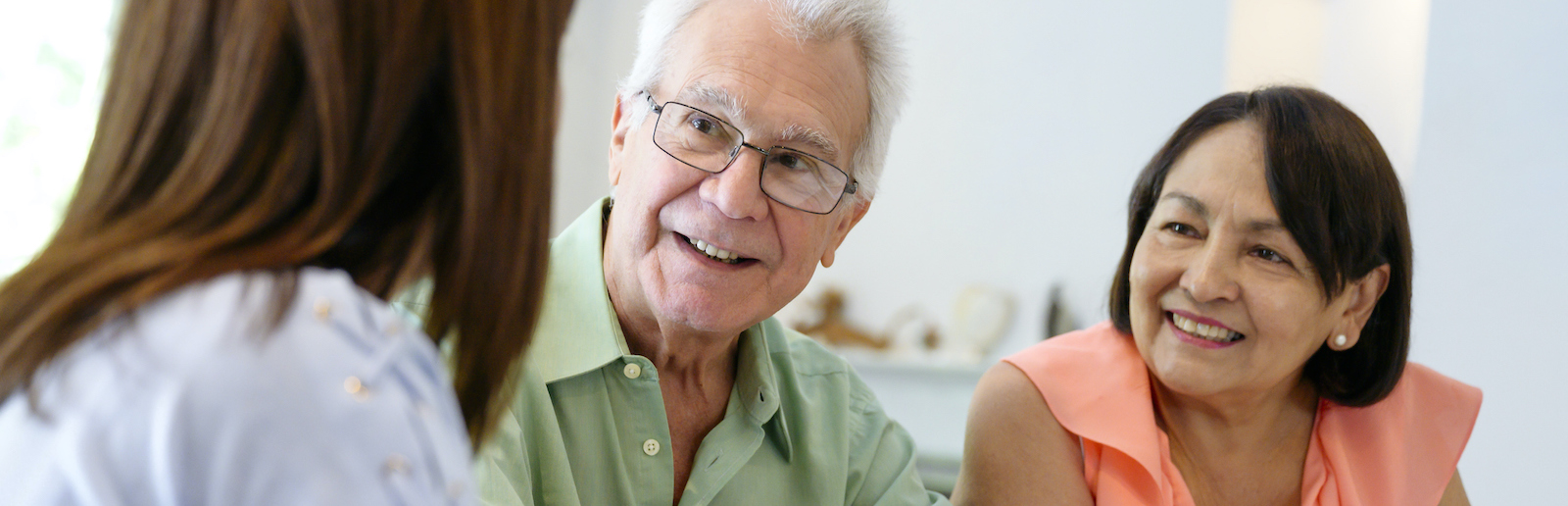 Hispanic senior couple meeting with financial advisor at home
