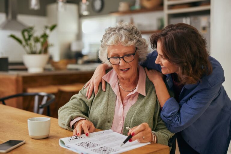 woman and elderly senior looking at paper