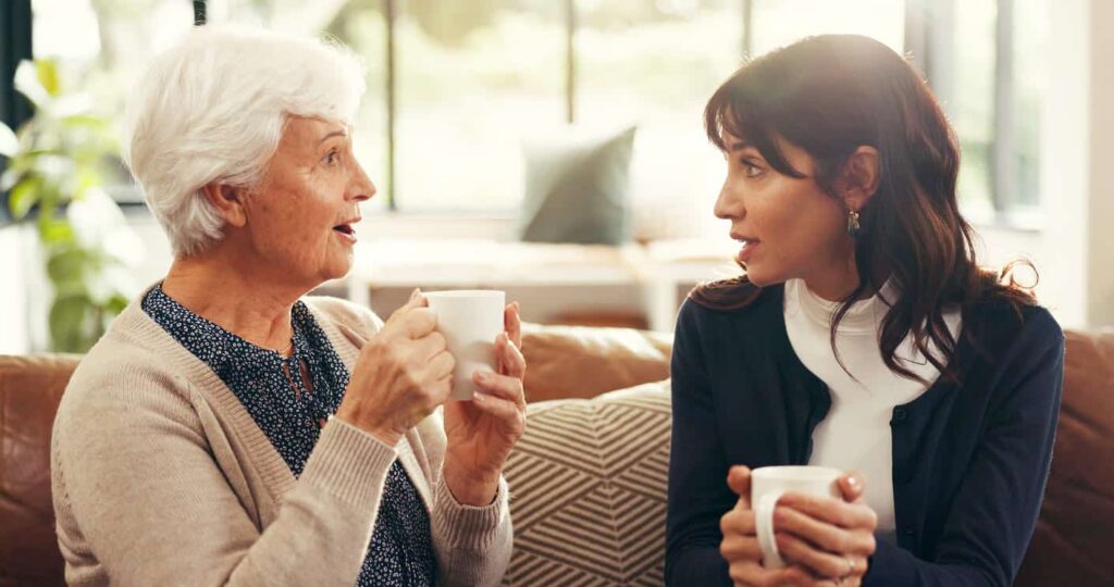 senior woman and daughter drinking coffee