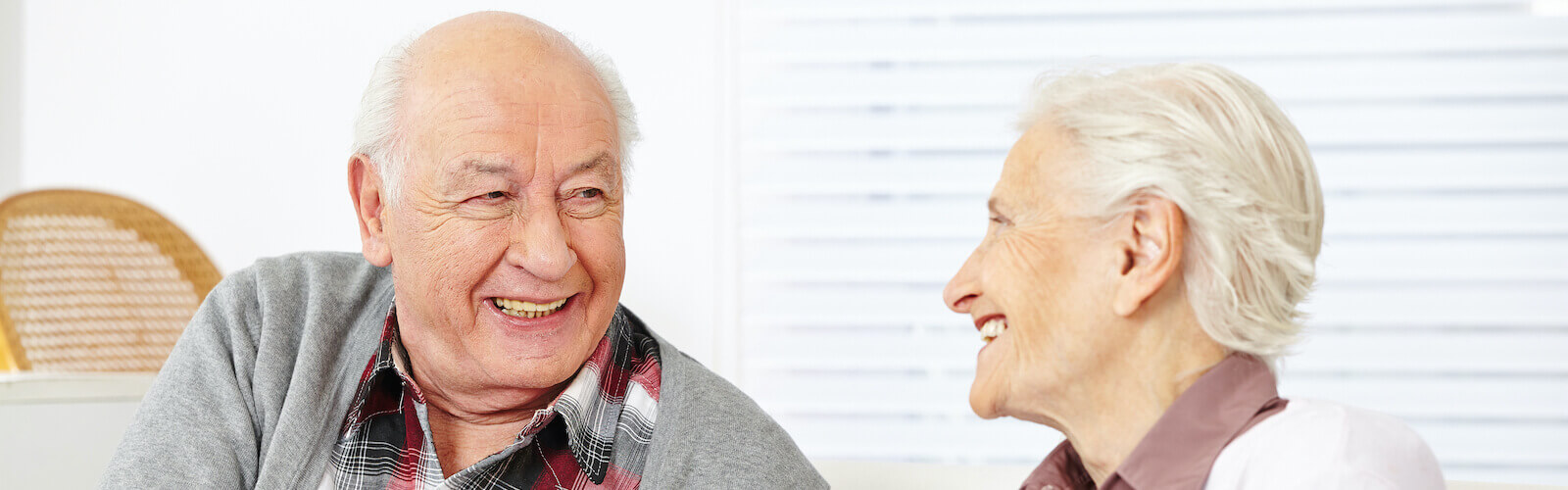 Elderly couple embracing each other.