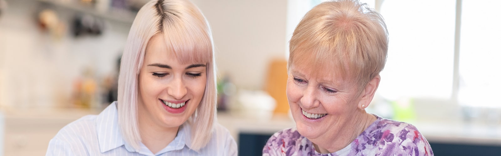 Health care worker helping an elderly man