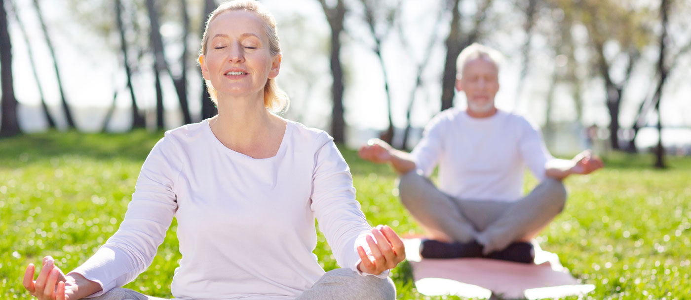 seniors practicing yoga outdoors at a retirement community